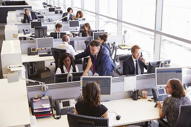 istock Manager in discussion with coworker in an open plan office 487808792