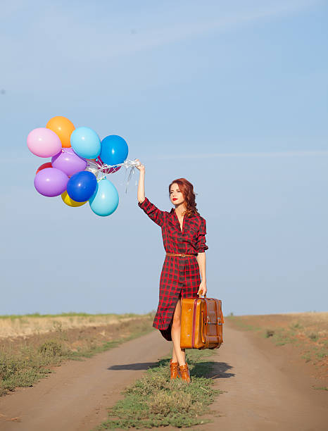 istock girl with multicolored balloons and bag 487808856