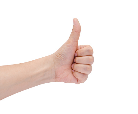 Female hand showing thumbs up sign against white background