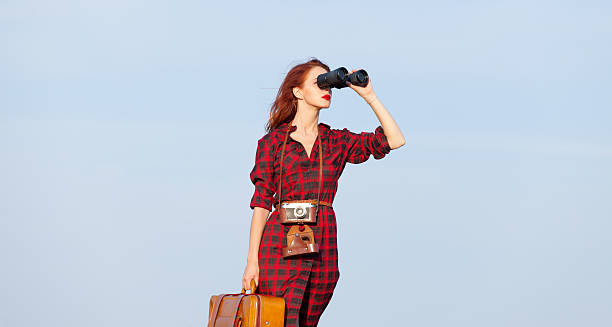 istock girl with bag and binocular 487809018
