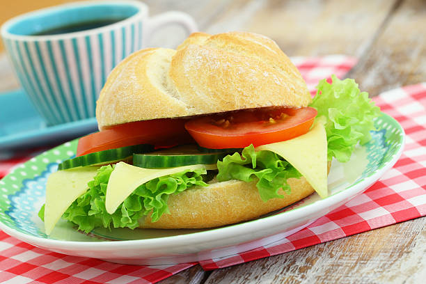 istock Cheese roll with lettuce, tomato and cucumber and coffee 487809502