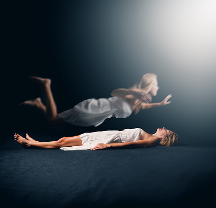 A conceptual image of a woman experiencing astral projection.