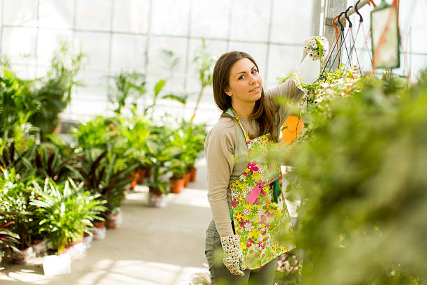istock Young woman in flower garden 487810185