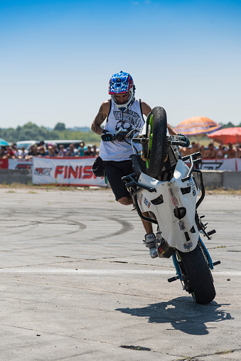 Vinnytsia,Ukraine-July 25, 2015: Unknown stunt biker entertain the audience before the start of the championship of drifting   on July 25,2015 in Vinnytsia, Ukraine.