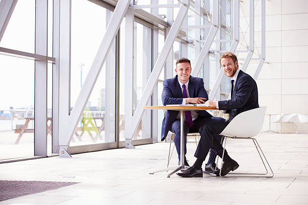 istock Two business colleagues in modern interior, looking to camera 487810616
