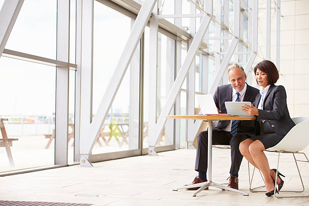 istock Two senior business colleagues at meeting in modern interior 487810862