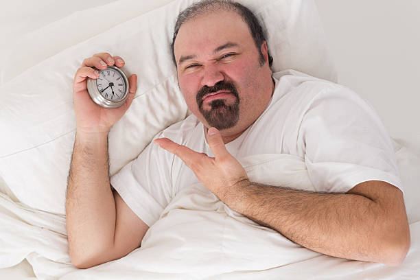 istock Man kept awake by noisy neighbours 487812183