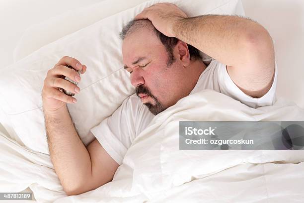 Man Suffering From A Hangover Stock Photo - Download Image Now - Adult, Adults Only, Alarm Clock