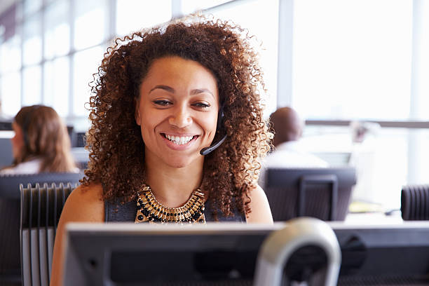 istock Female call centre worker, looking at screen, close-up 487813756