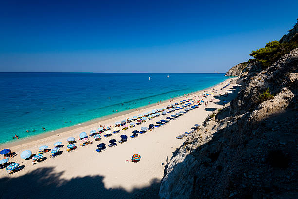 Beautiful clear sea at Egremni beach in Lefkada blue water, green water, lefkada island, greece, ionian sea, beach, holidays, lefkas, levkas, summer, clear sky, blue sky, tourists, rocks, travel, sandy beach, sand, famous, egremni, egremnoi, ship, cruiser, view, amazing egremni beach lefkada island greece stock pictures, royalty-free photos & images