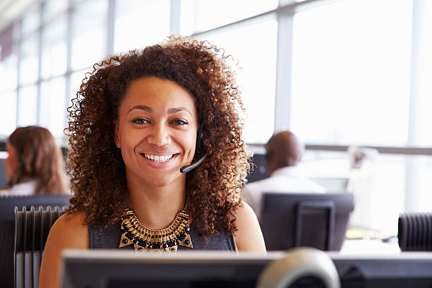 istock Woman working in a call centre, looking to camera, close-up 487813922