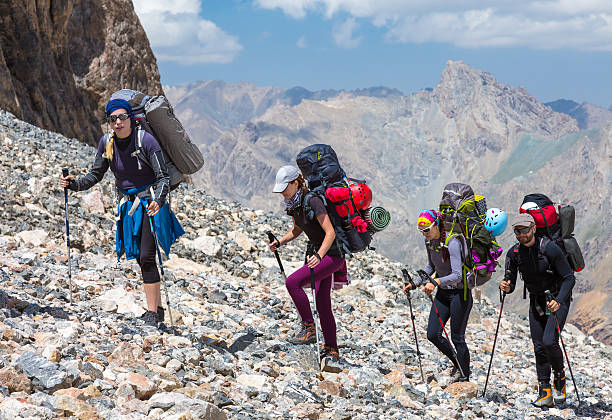 istock Group of Mountaineer Walking on Deserted Rocky Terrain 487814954