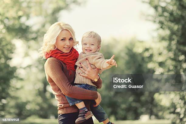 Portrait Happy Mother And Child Playing In Autumn Stock Photo - Download Image Now - 2015, Adult, Autumn