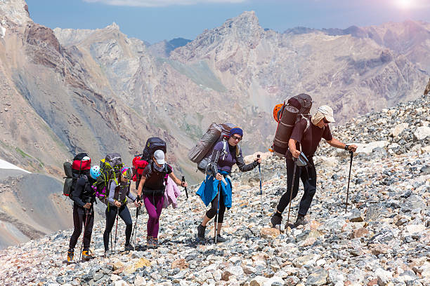 istock Group of Hikers Walking on Deserted Rocky Terrain 487815052