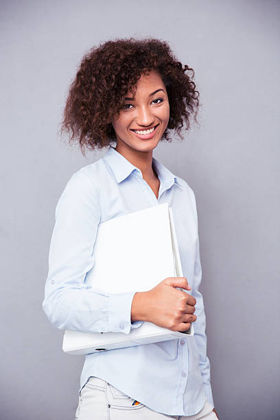 istock Afro american businesswoman standing with folder 487815092