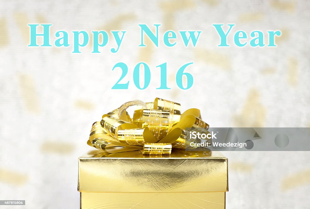 Golden Present with Happy New Year 2016 word at bokeh Golden Present box with Happy New Year 2016 word at bokeh light background, Holiday concept. 2015 Stock Photo