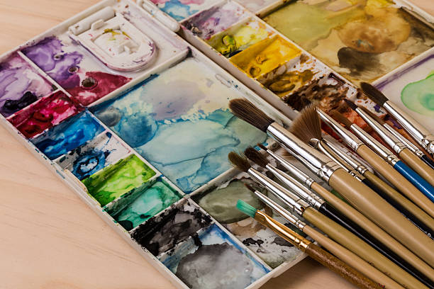 art palette with brushes and paints used art palette with brushes and paints tempera painting variation abstract colors stock pictures, royalty-free photos & images