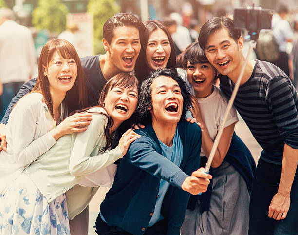 istock Happy japanese friends taking a selfie 487819578