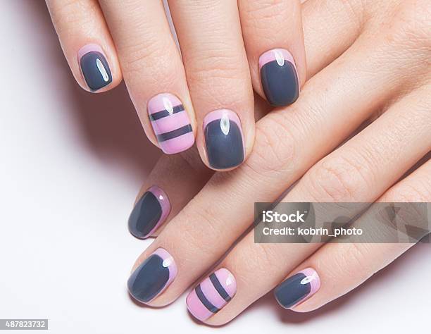 Beautiful Womens Manicure With Gray And Pink Polish On Stock Photo - Download Image Now