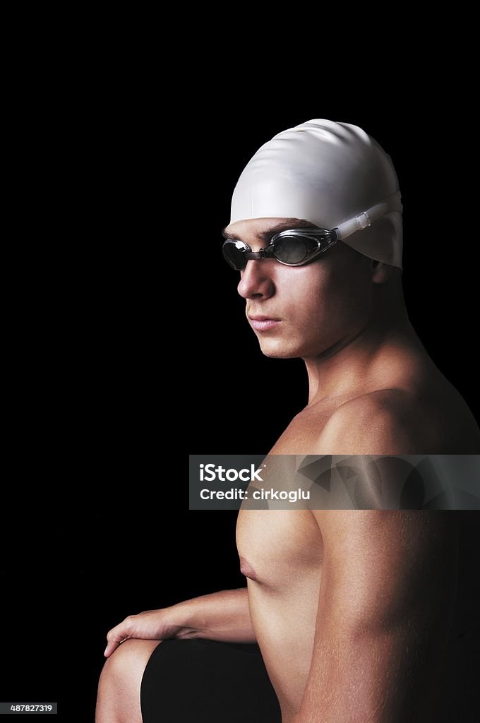 Portrait of muscular male swimmer Male swimmer isolated on black Abdomen Stock Photo