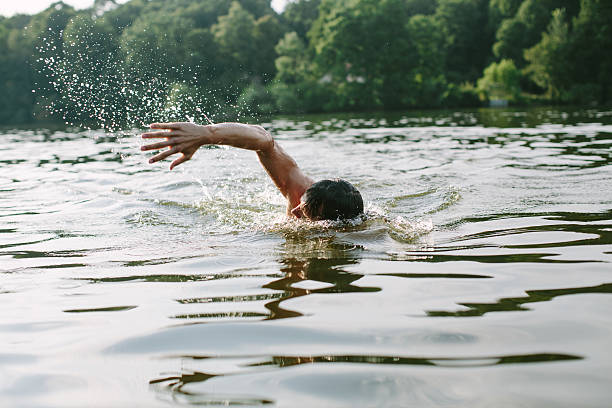Young man swimming in a lake