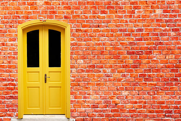 istock Yellow Door And Brick Wall 487829001