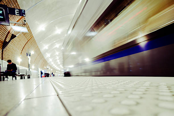 Train Station Platform, Monaco Montecarlo Train approacing the platform. Unrecognizable people. Blurred motion. Copy space. monaco rail station stock pictures, royalty-free photos & images