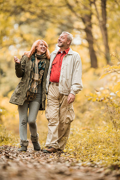 istock Smiling mature couple taking a walk in the forest. 487830936
