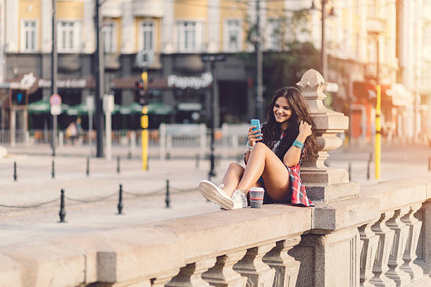 istock Girl at the bridge texting on smartphone 487831152
