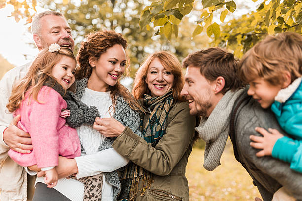 istock Smiling multi-generation family communicating while spending their day outdoors. 487831368