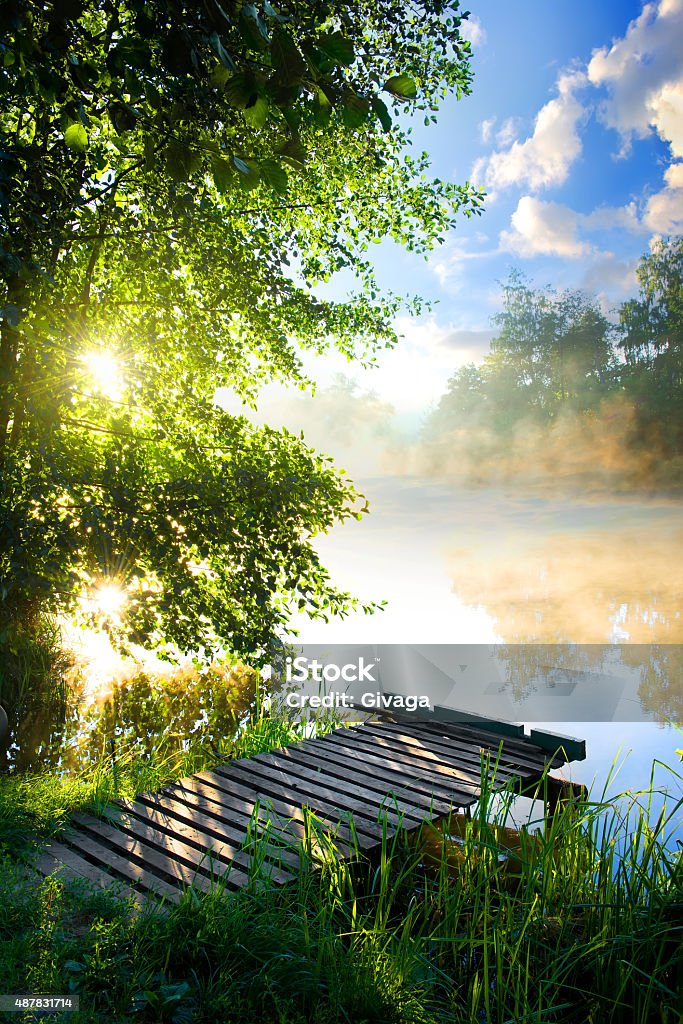 Fishing pier on river - Royaltyfri Sommar Bildbanksbilder