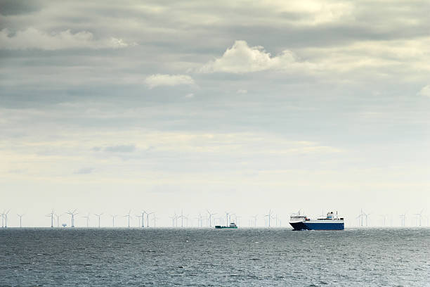 istock Ferry and windmills in ocean sustainable industry 487831758