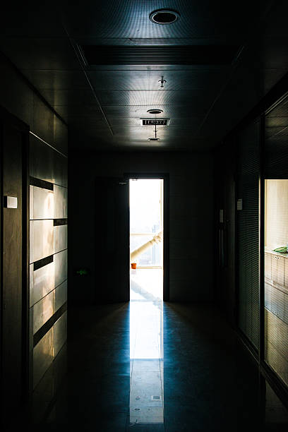 istock through a dark hallway to a light room 487831919