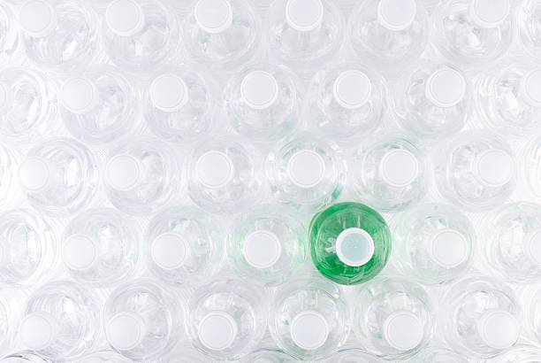 Overhead View of Plastic Water Bottles with One that has Green Colored Contents