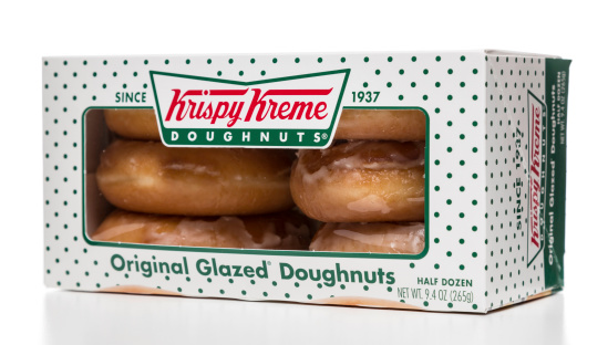 Miami, USA - April 20, 2014: Krispy Kreme original glazed doughnuts half dozen box. Krispy Kreme brand is owned by HDN Development Corporation.