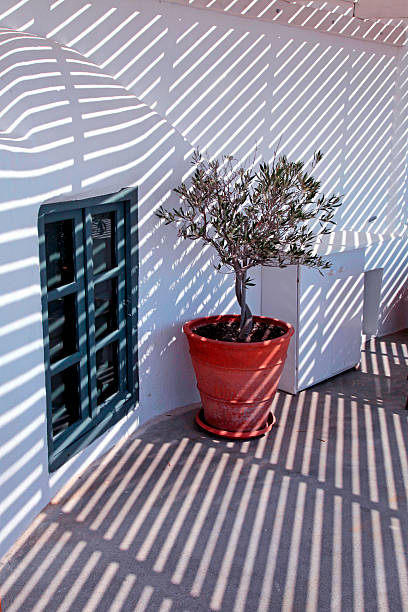 istock white architectural details with striped shadow, Santorini 487834704