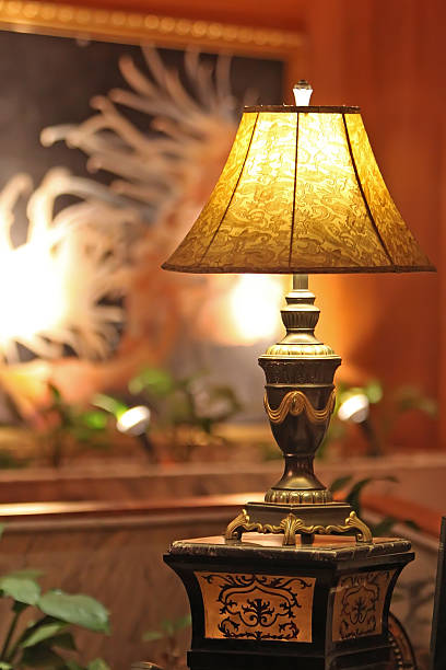 istock Table lamp stands on a pedestal yellow light shines 487836126