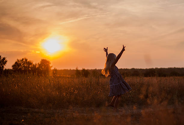 istock child in a field at sunset 487836934