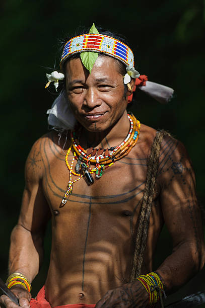 Portrait of Teo Tak Gogo West Sumatera, Indonesia-June 15,2014: A portrait of Teo Tak Gogo, 55, The indigenous inhabitants ethnic of the islands in Muara Siberut are also known as the Mentawai people. Mentawai Islands stock pictures, royalty-free photos & images