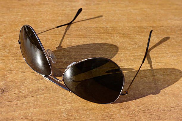 istock Mens sunglasses on wooden background close up 487837172