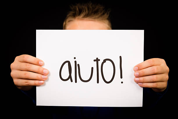 istock Child holding sign with Italian word Aiuto - Help 487841086