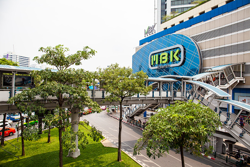 Bangkok, Thailand - March 22, 2015: MBK Center in front connected with BTS sky train. MBK Center is a large shopping mall in Bangkok, Thailand.