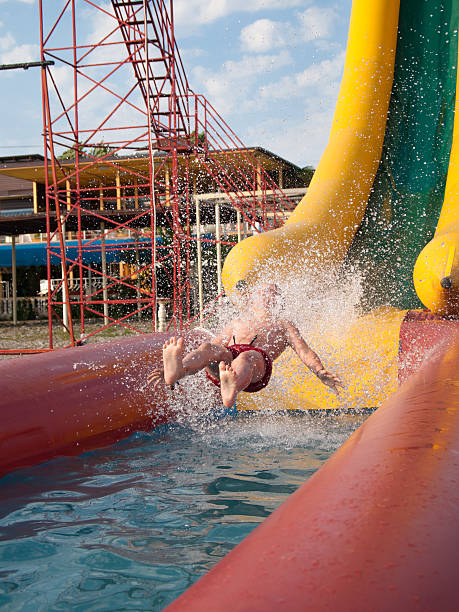 istock Boy slides down the water slides 487852139