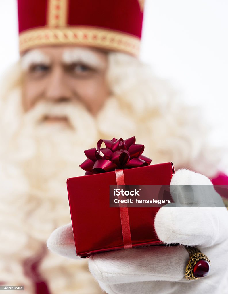 Sinterklaas showing gift sinterklaas  with gift . typical Dutch character part of a traditional event celebrating the birthday of Sinterklaas (Santa Claus) in december.Selective focus on gift Gift Stock Photo