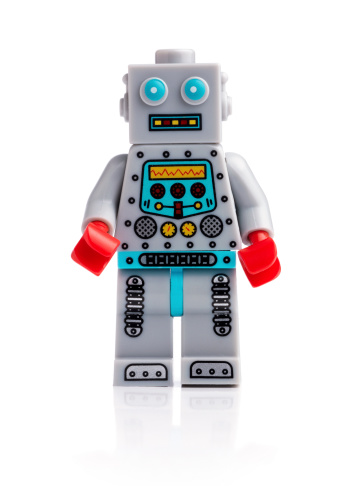London, United Kingdom- April 17, 2014: Lego mini figure Clockwork Robot on white background. From the collectible Mini figure Series 6 The lego figure is a small plastic toy made by a Danish toy manufacturer the Lego Group.