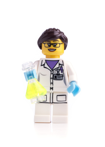 London, United Kingdom- April 17, 2014: Lego mini figure Scientist on white background. From the collectible Mini figure Series 11. The lego figure is a small plastic toy made by a Danish toy manufacturer the Lego Group.
