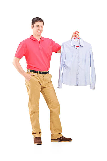 istock Man holding shirt on a hanger 487854305