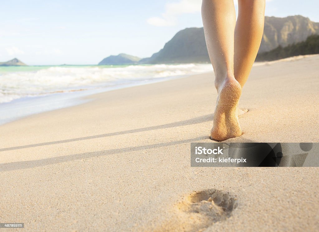 Walking on the beach Young woman walking on the beach in Hawaii, USA. Beach Stock Photo