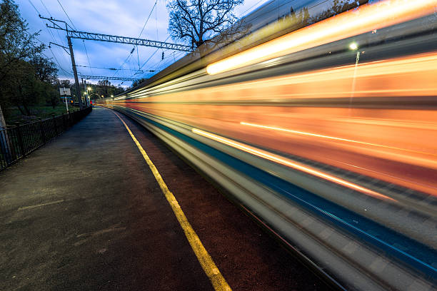 istock Night high-speed train in motion blur showing light trails 487855183