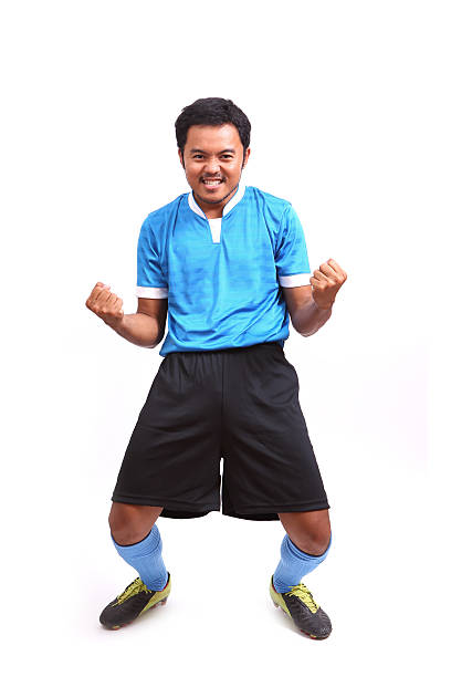 Young soccer football player on white